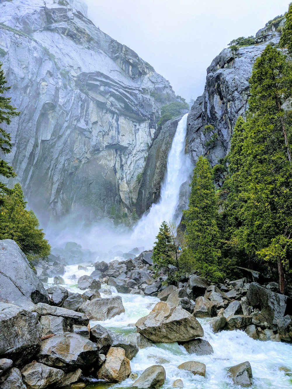 a waterfall in the middle of a rocky river