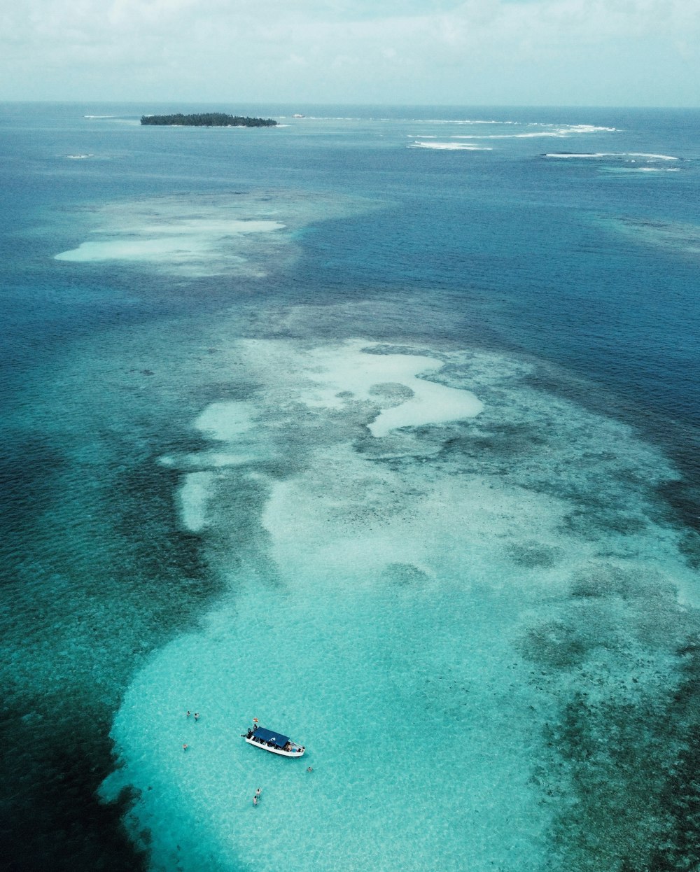 Una barca che galleggia in cima a un grande specchio d'acqua