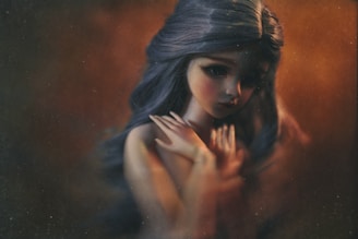 A delicate and stylized figure with long flowing hair, positioned with a gentle and introspective demeanor. The background is a mix of warm, glowing hues that create an artistic and dreamy atmosphere. The figure's expression is soft, with a slightly tilted head and hands gently clasped near the chest.