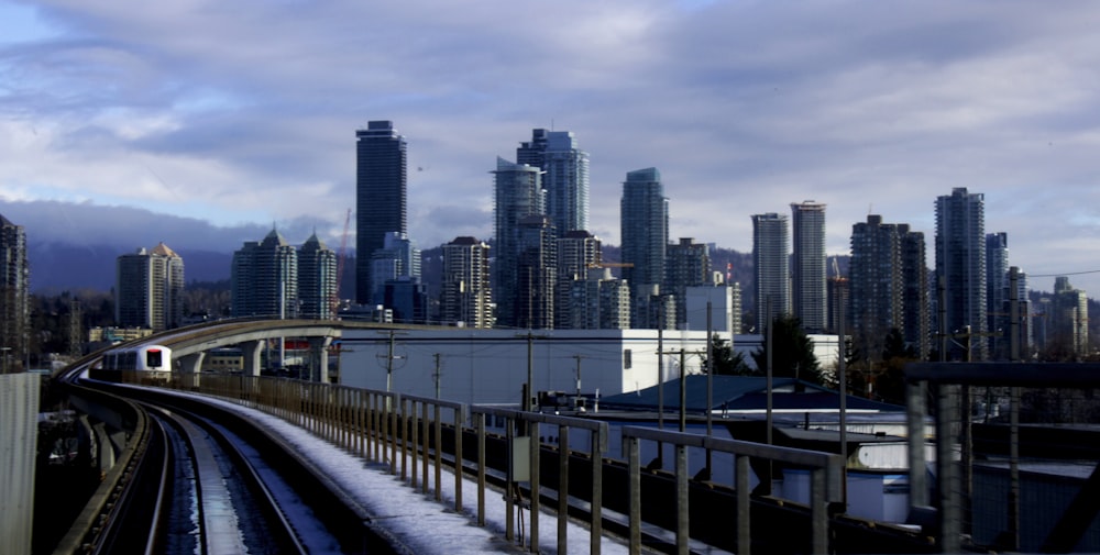 a view of a train track with a city in the background