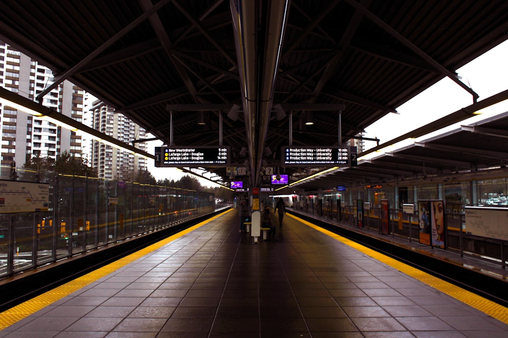 a train station with a train on the tracks