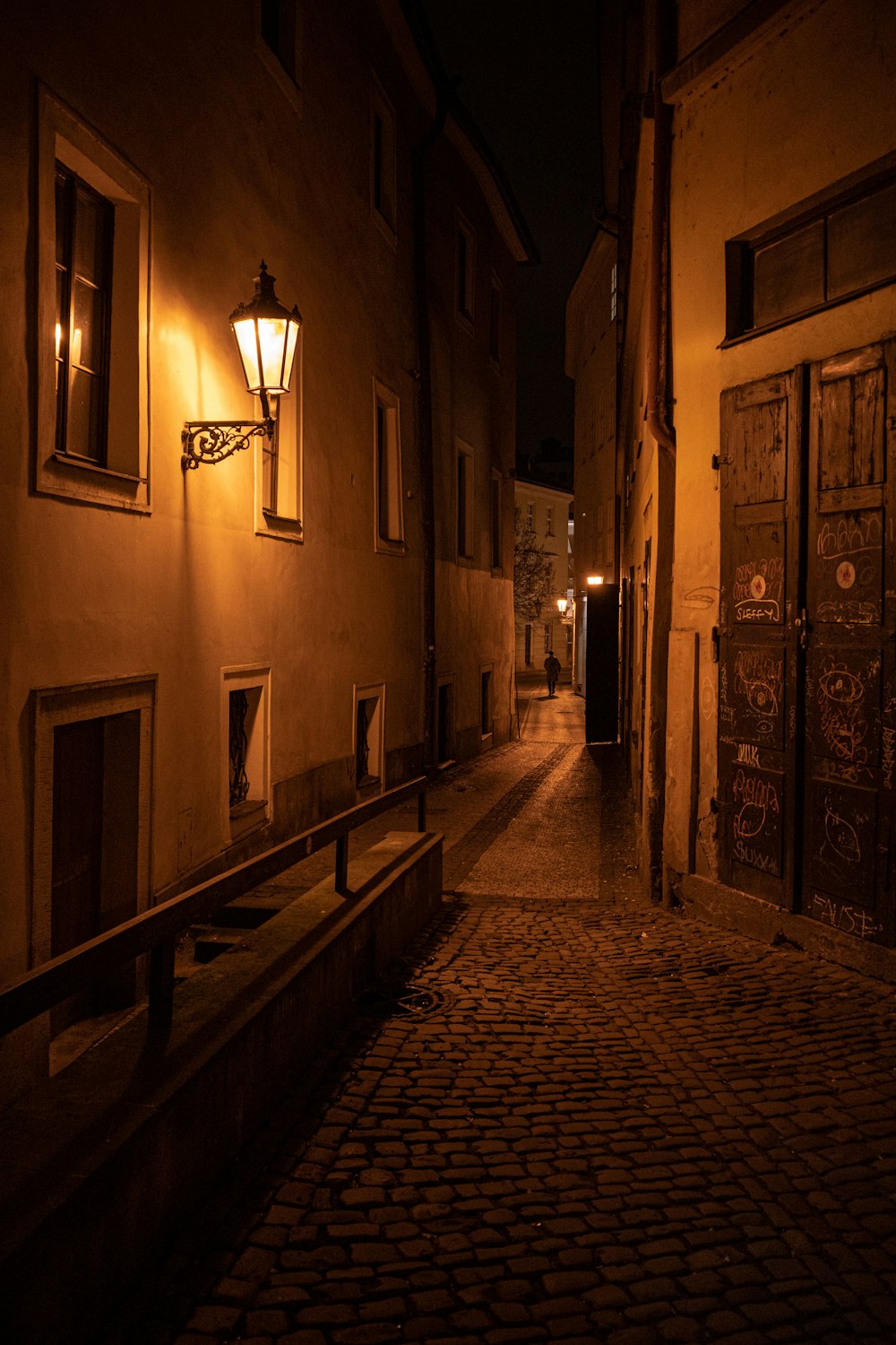 a dark alley at night with a light on
