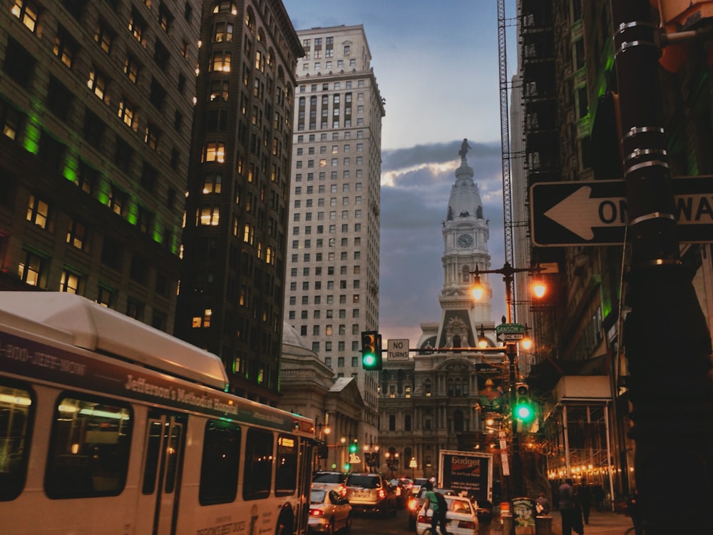 a city street filled with traffic next to tall buildings