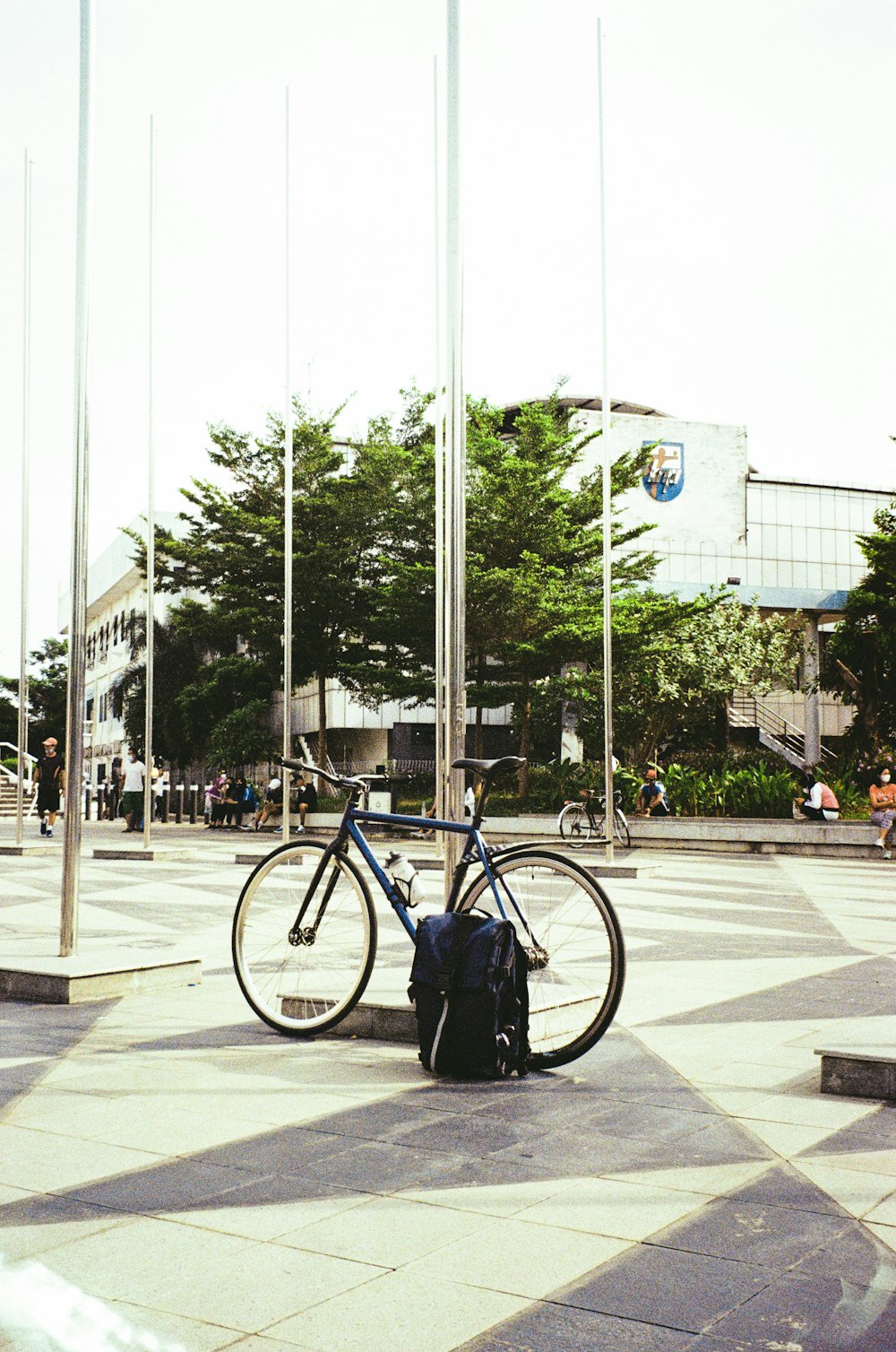 a bicycle parked next to a flag pole