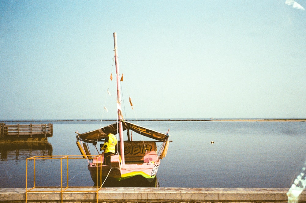 a small boat sitting on top of a body of water