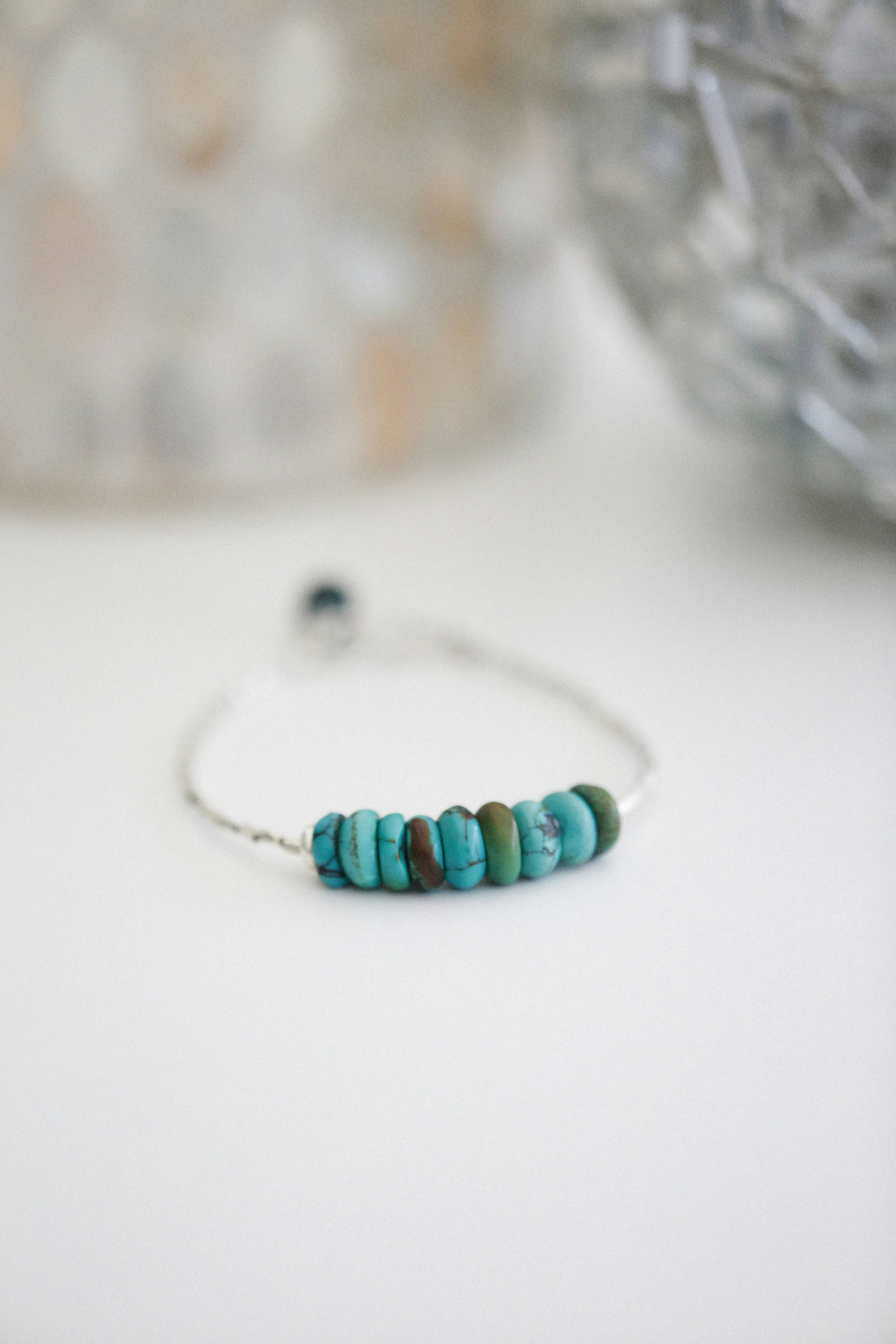 Silver handmade bracelet on white surface