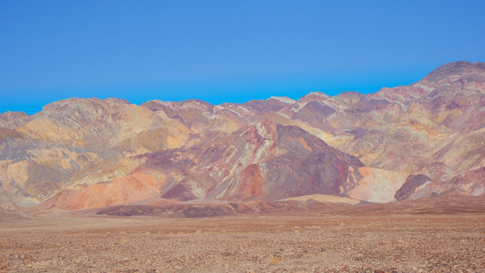 a mountain range with a blue sky in the background