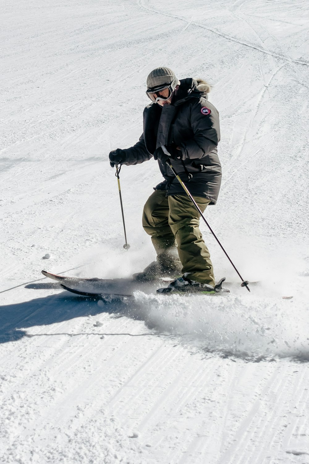 a man riding skis down a snow covered slope