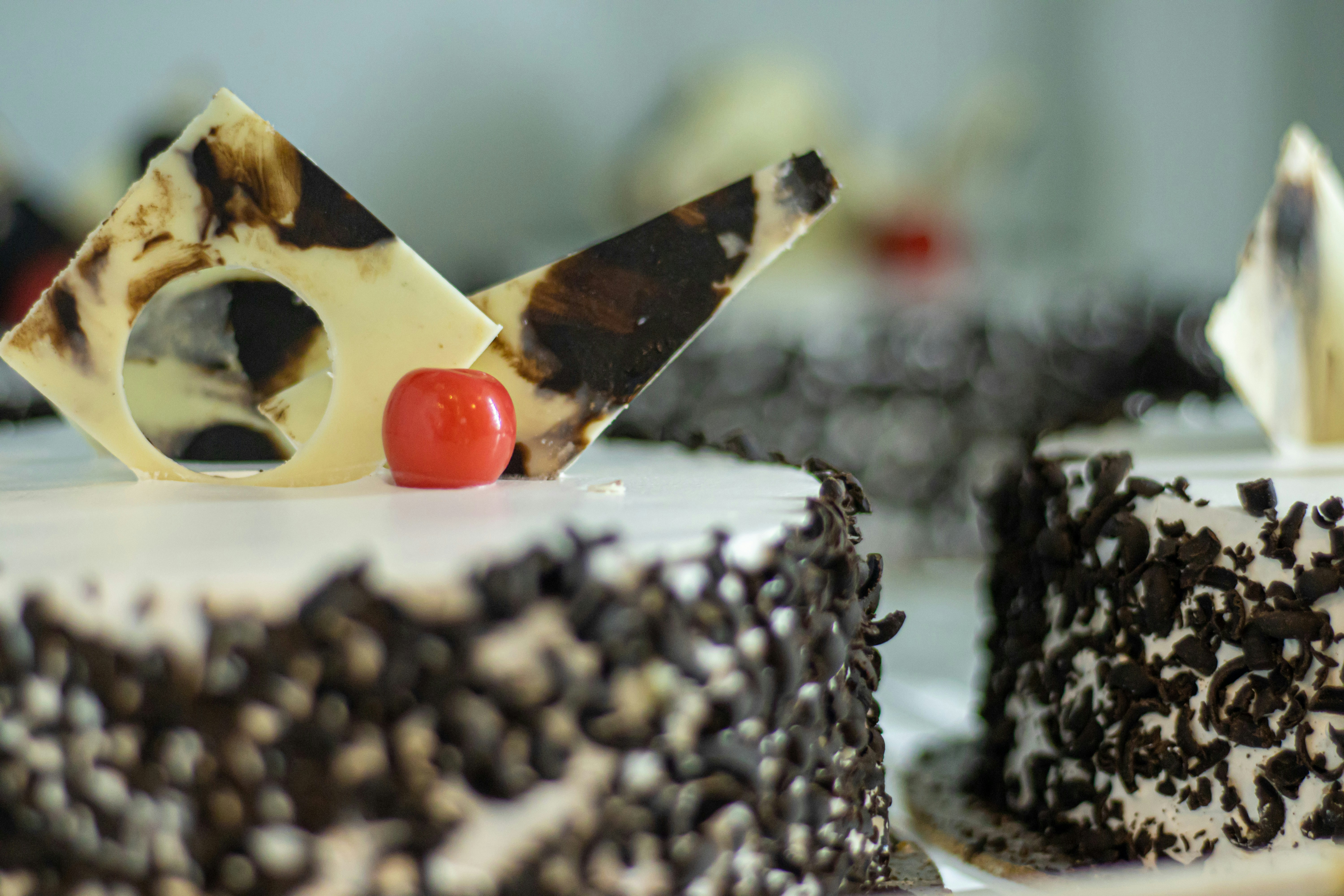 a close up of a cake with a cherry on top