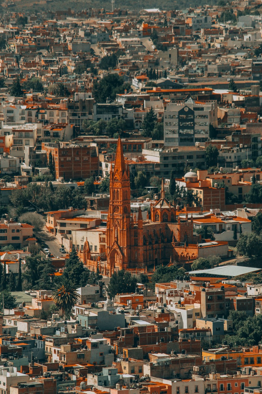 a very tall church tower towering over a city