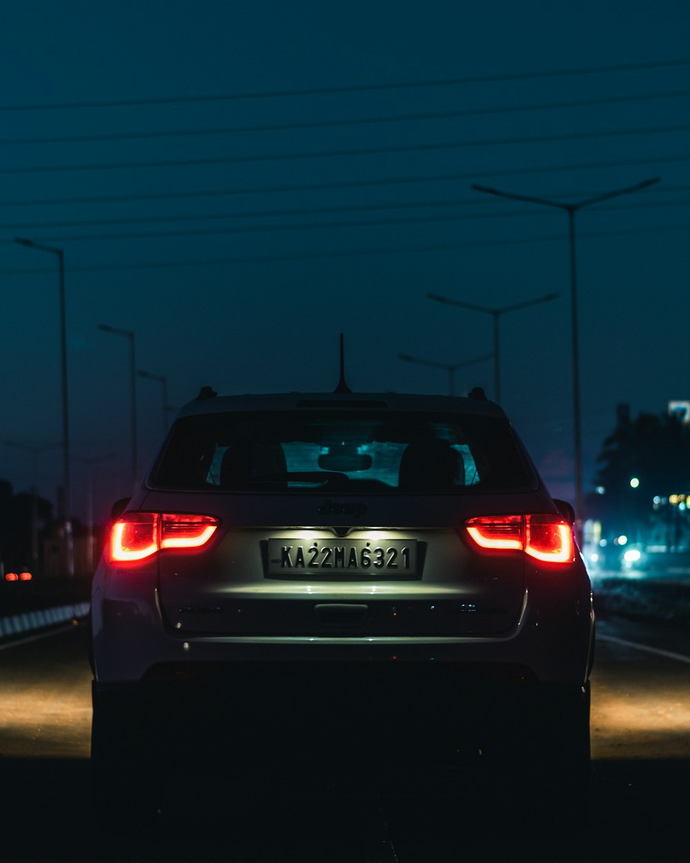 a car driving down a street at night