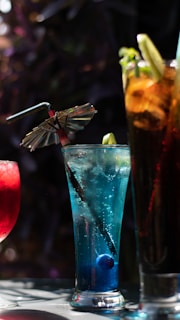 a table topped with three different types of drinks