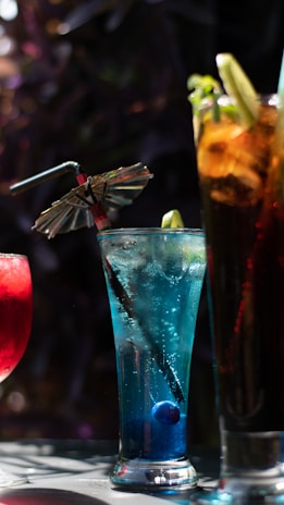 a table topped with three different types of drinks