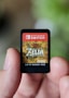 a hand holding a nintendo wii game card