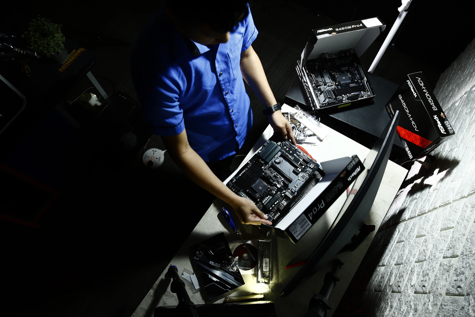 a man in a blue shirt working on a computer