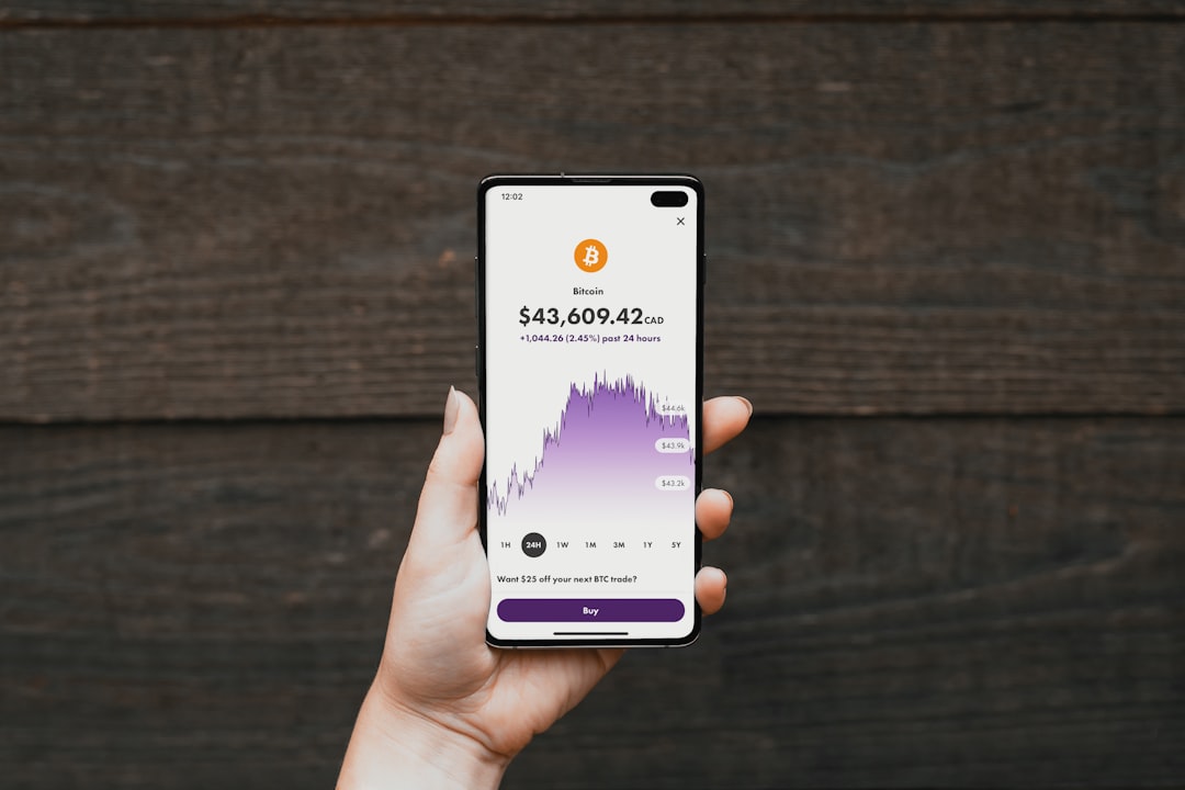 a person holding a cell phone in their hand, Easily buying crypto with Wealthsimple</p>
<p>
