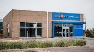 an empty parking lot in front of a bank of america