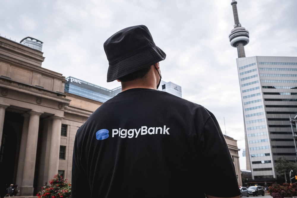 a man wearing a piggy bank shirt and a hat