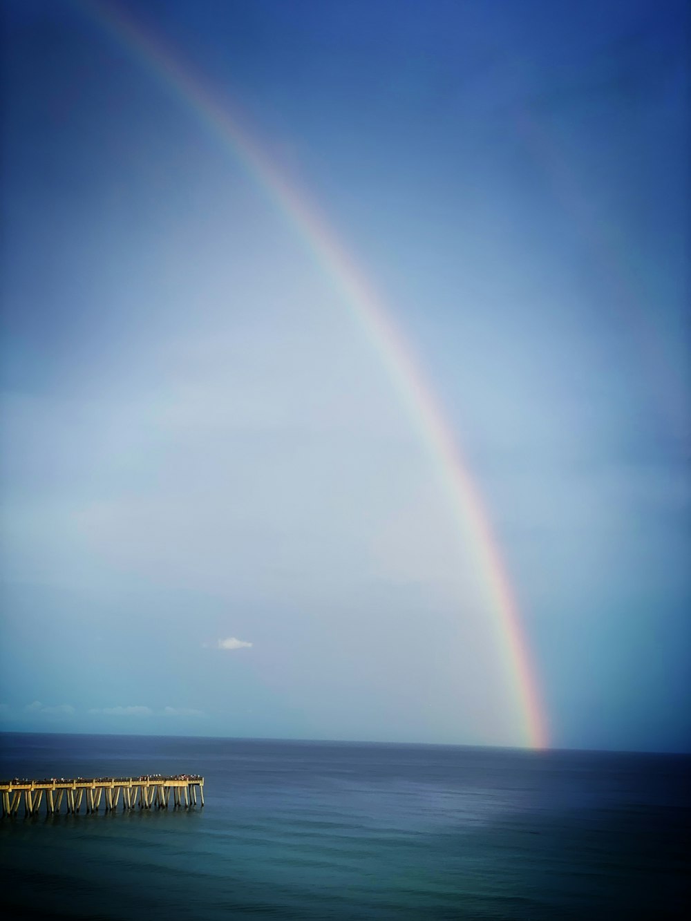 a rainbow in the sky over a body of water