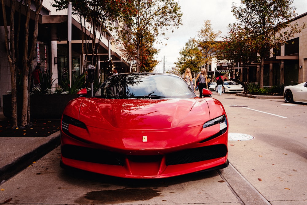 a red sports car parked on the side of the road