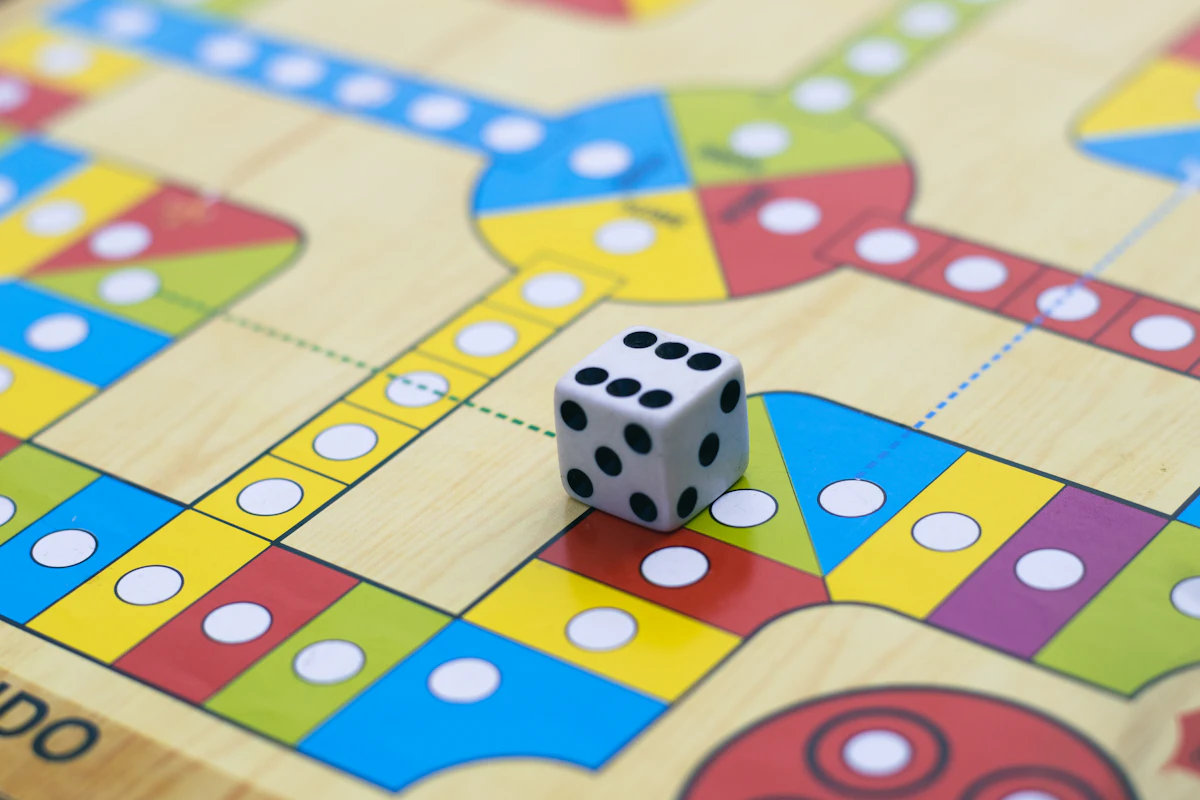 A colorful board game close-up with a die, ready for the next turn