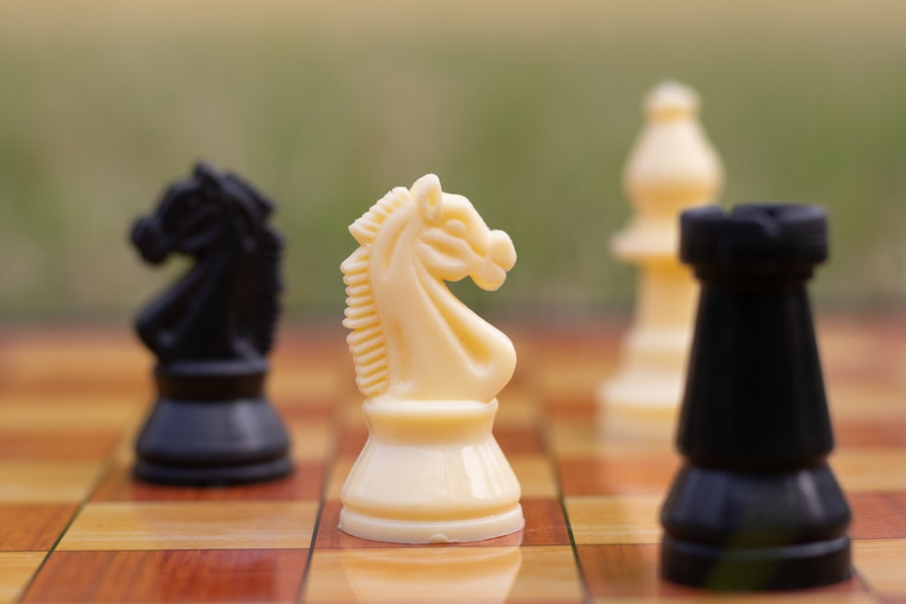 a group of chess pieces sitting on top of a chess board