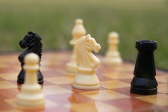 a group of chess pieces sitting on top of a chess board