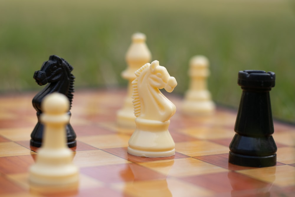 a group of chess pieces sitting on top of a chess board