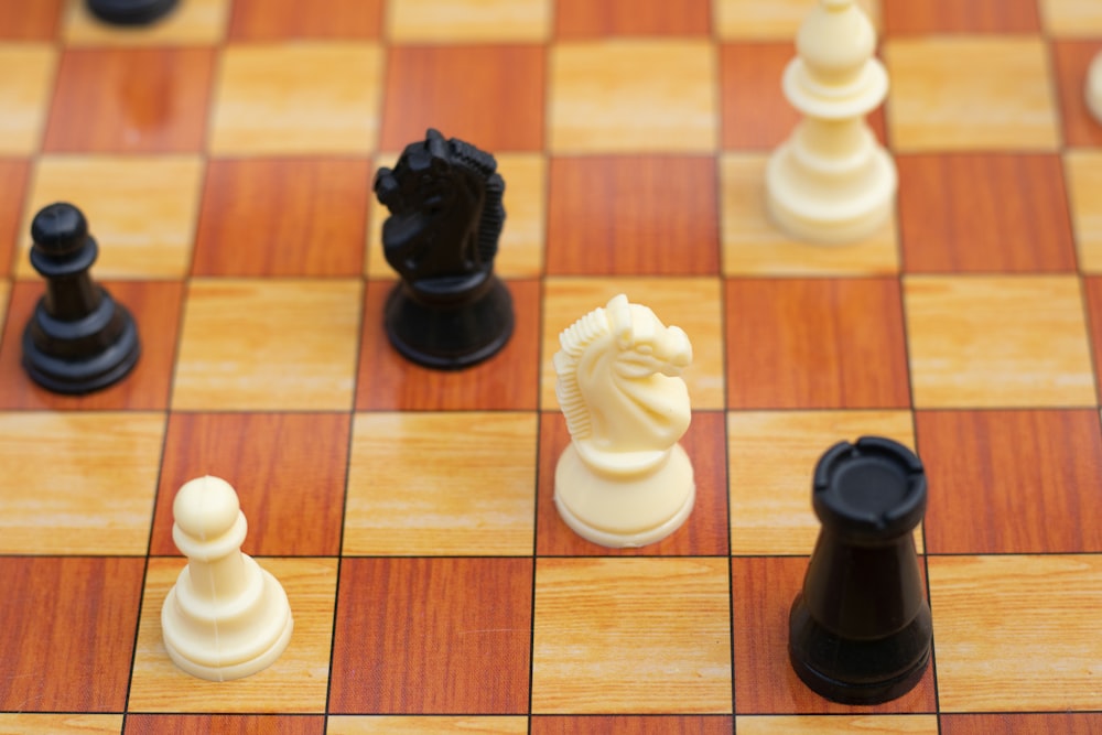 a close up of a chess board with pieces on it