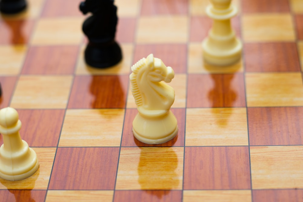 a close up of a chess board with pieces on it