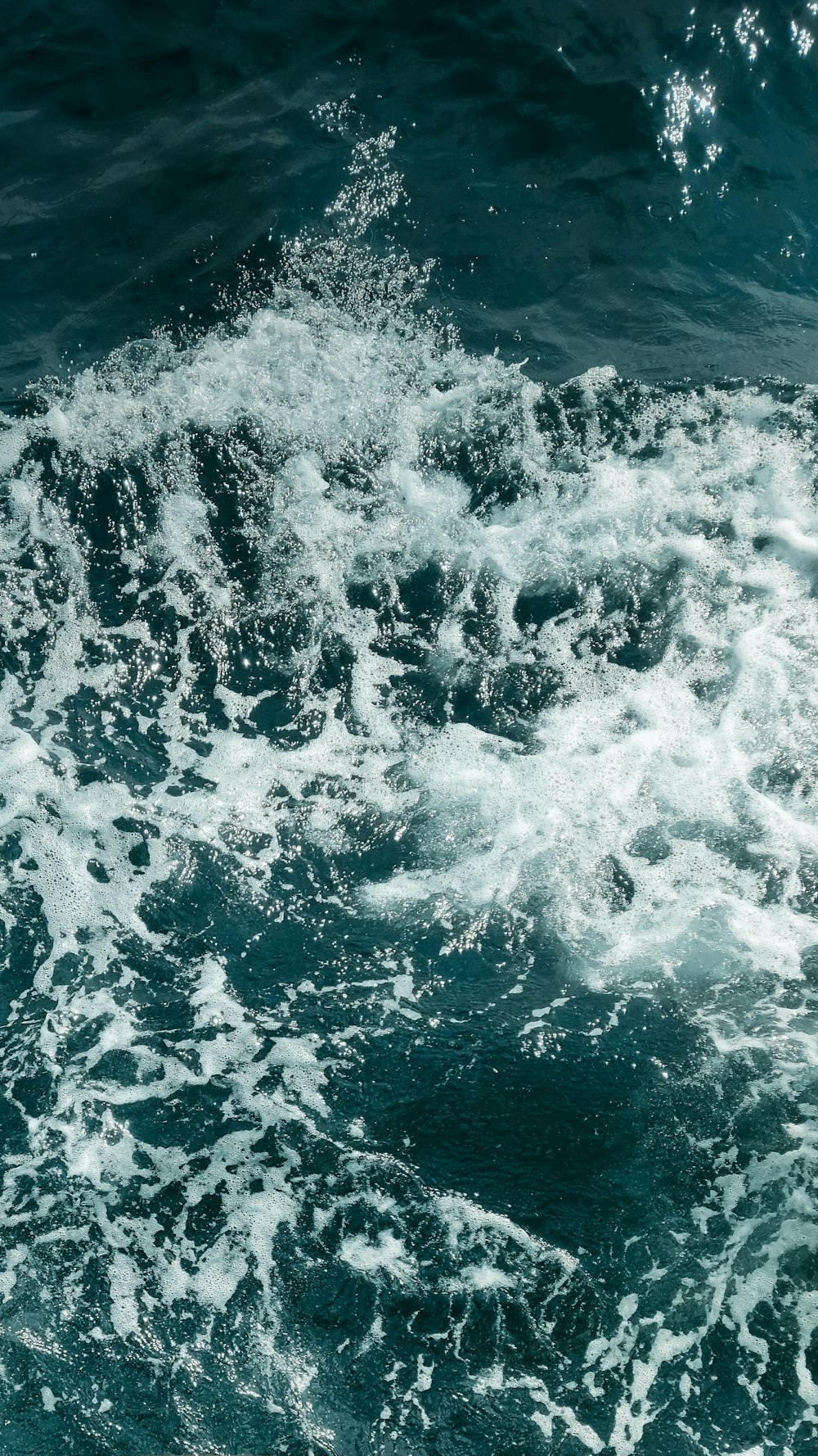 a man riding a surfboard on top of a wave in the ocean