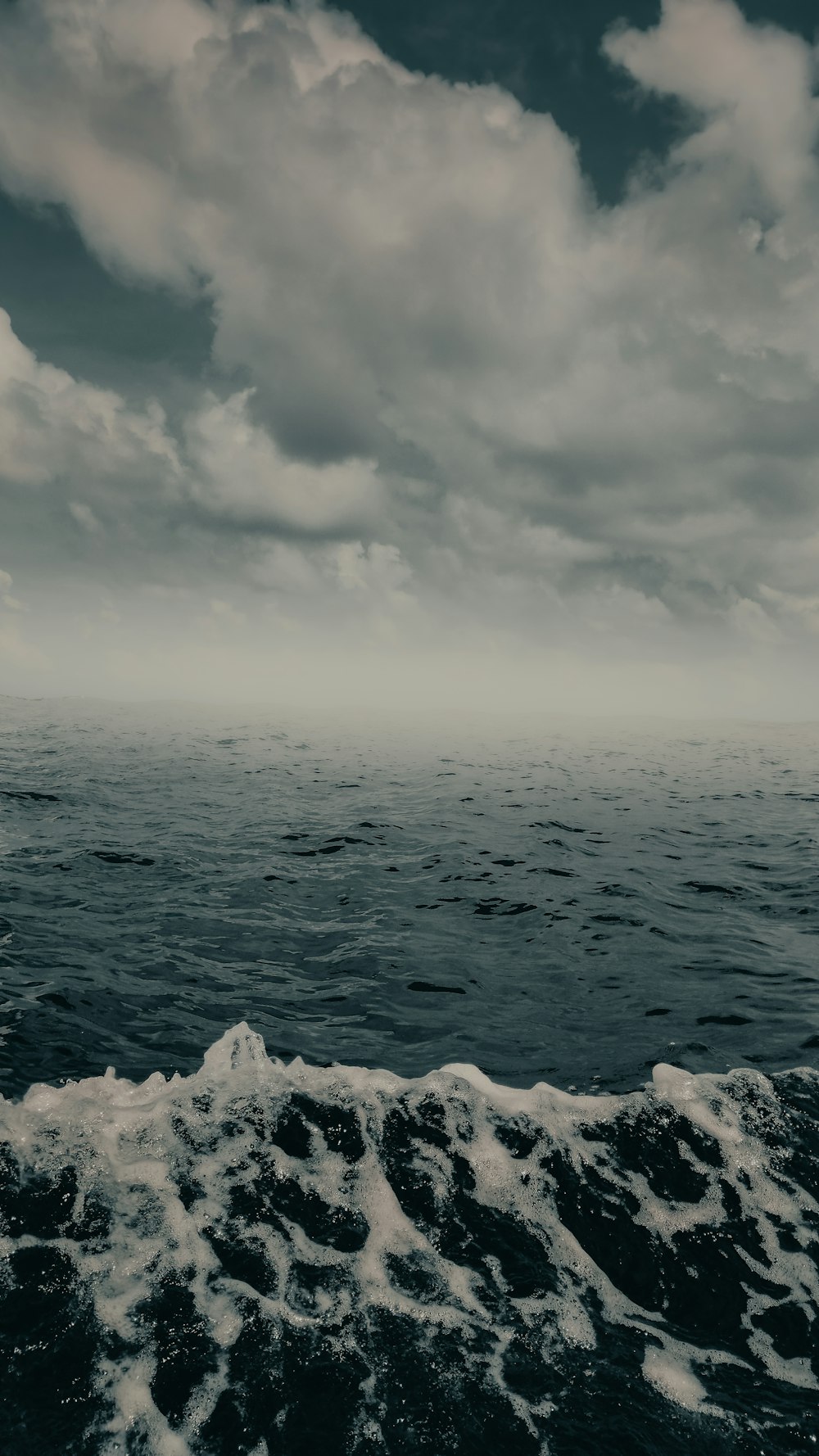 a large body of water under a cloudy sky