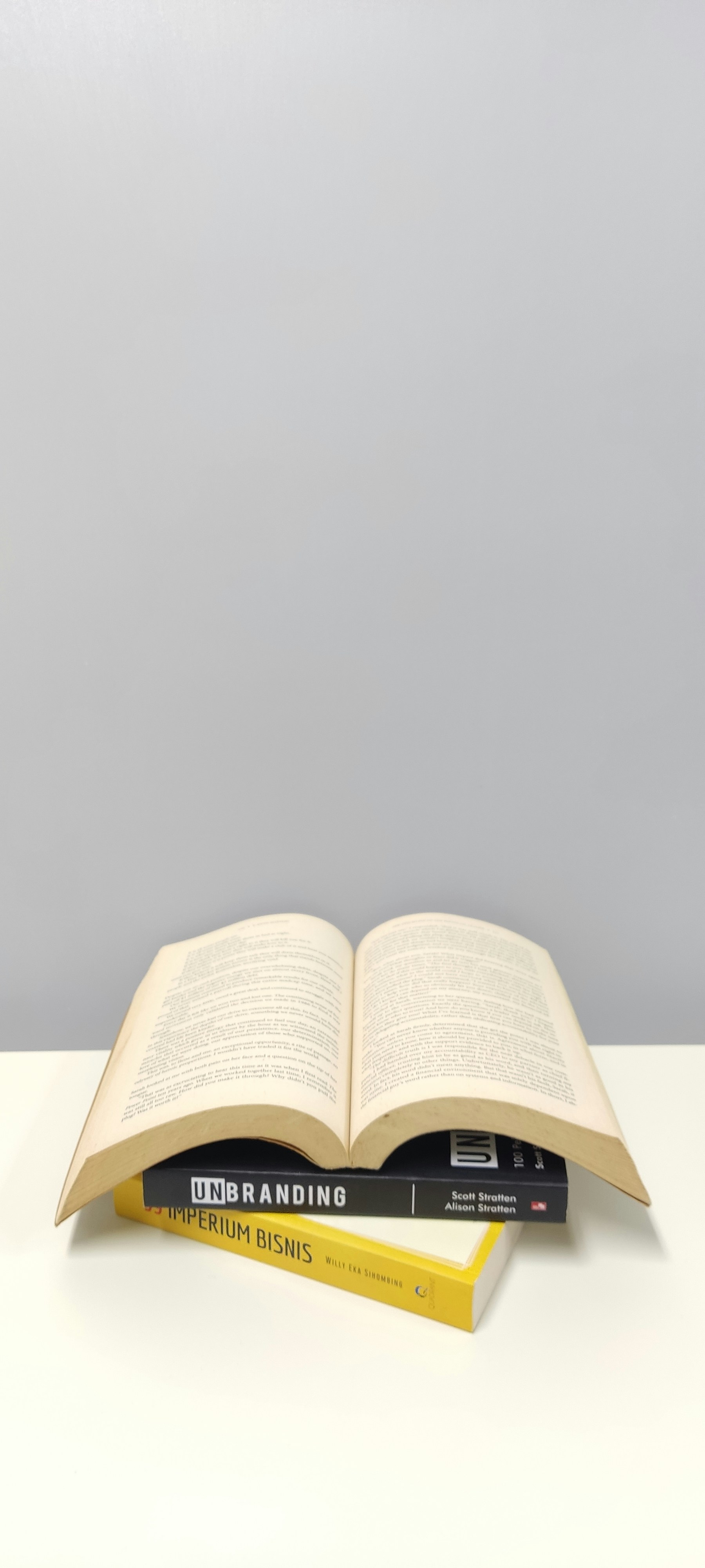 two books sitting on top of each other on a table