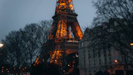 the eiffel tower is lit up at night