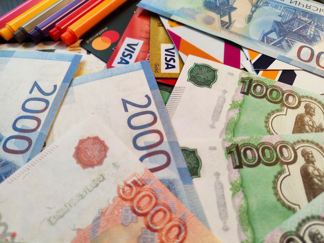 a pile of different currency sitting on top of each other, Russian paper money banknotes RUR roubles 1000, 2000, 5000 rubli bills and credit cards on the white background, Free stock photo for finance and banking content
