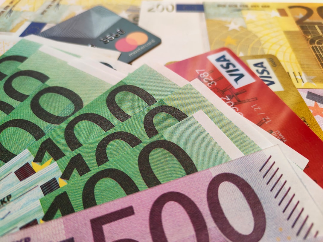 a pile of money with a credit card sticking out of it, European Euros EUR paper banknotes. Free stock editorial photo for blog content, online magazines and other resources covering banking and financial topics