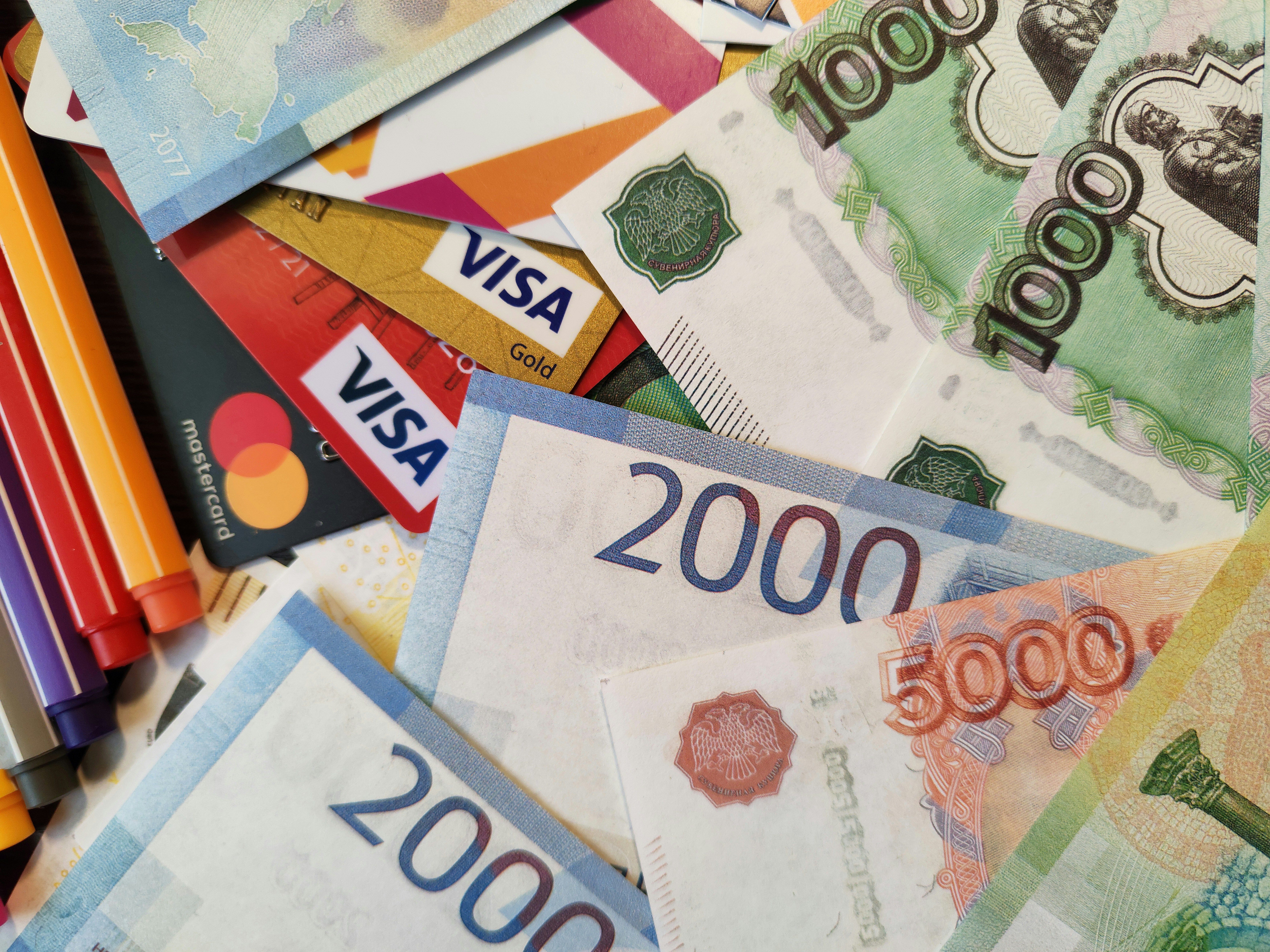 Russian RUR Rubli Roubles paper banknotes and credit cards, closeup shot from above. Free stock editorial photo for blog content, online magazines and other resources covering banking and financial topics