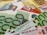 A close-up of various euro banknotes and credit cards arranged together. The focus is on the 100 euro bills, with multiple denominations of euro bills and several credit cards, including VISA and Mastercard, scattered in the background.