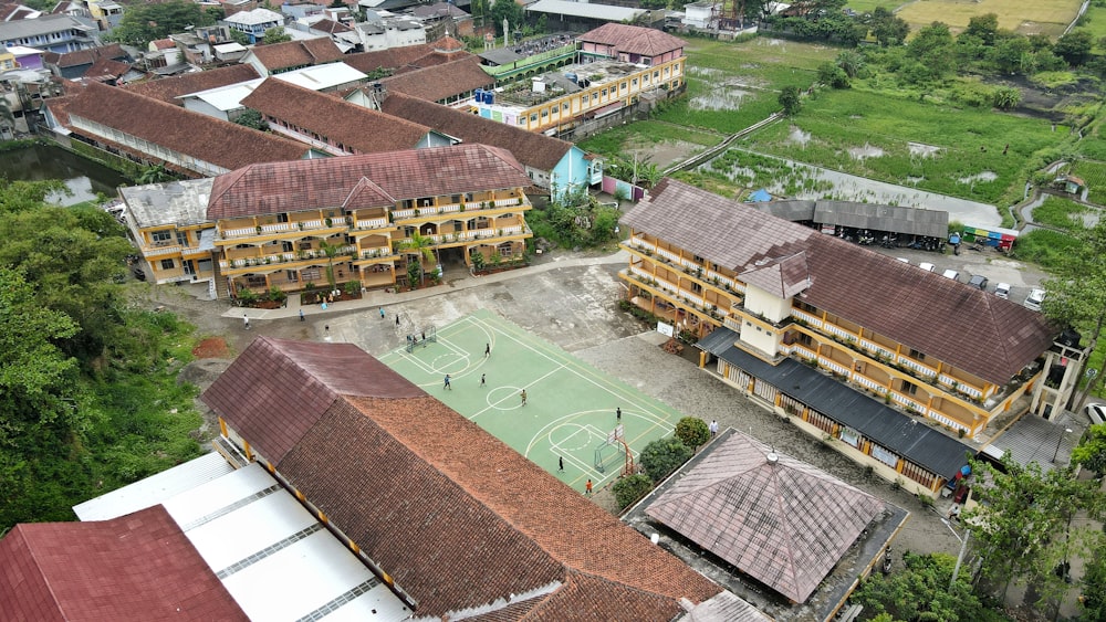 an aerial view of a village with a soccer field