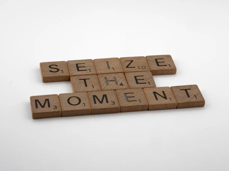 scrabble tiles spelling the word seize the moment