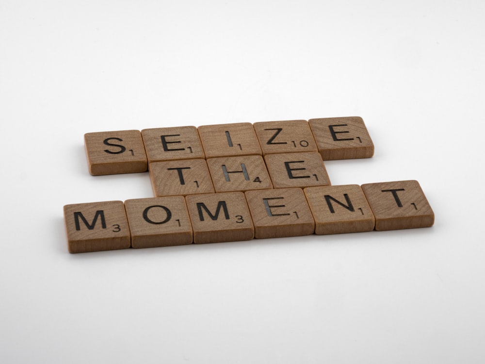 scrabble tiles spelling the word seize the moment