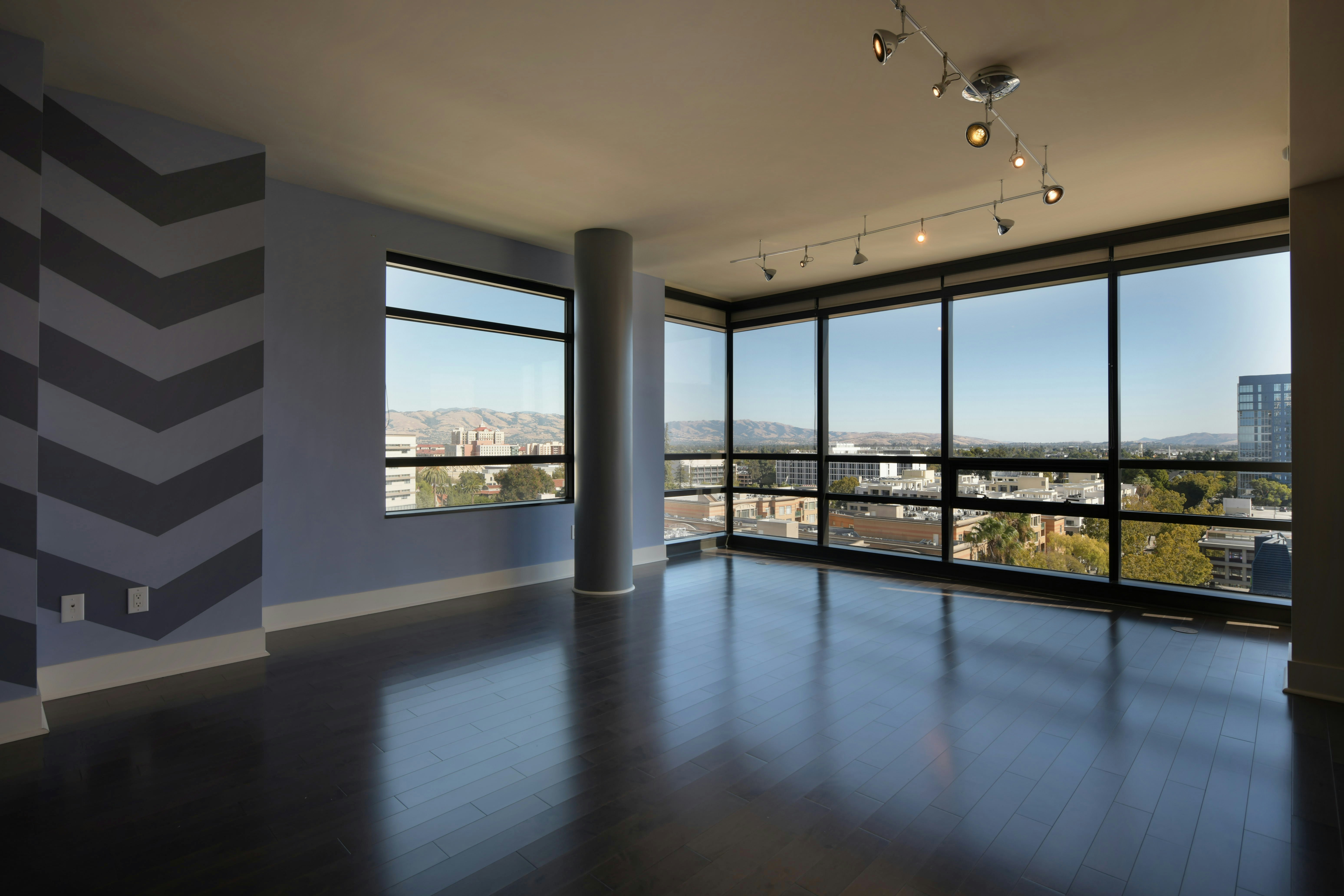 Modern apartment yoga studio with floor-to-ceiling windows, natural lighting, and city views - apartments with yoga studio