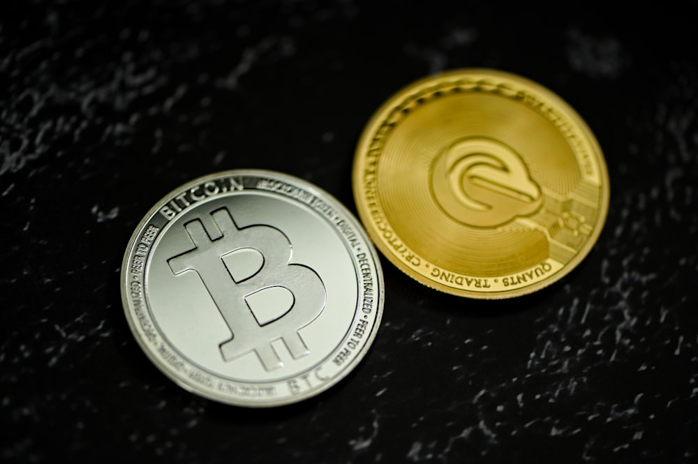 two bitcoins sitting side by side on a table