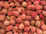 a pile of lychee fruit sitting on top of a table