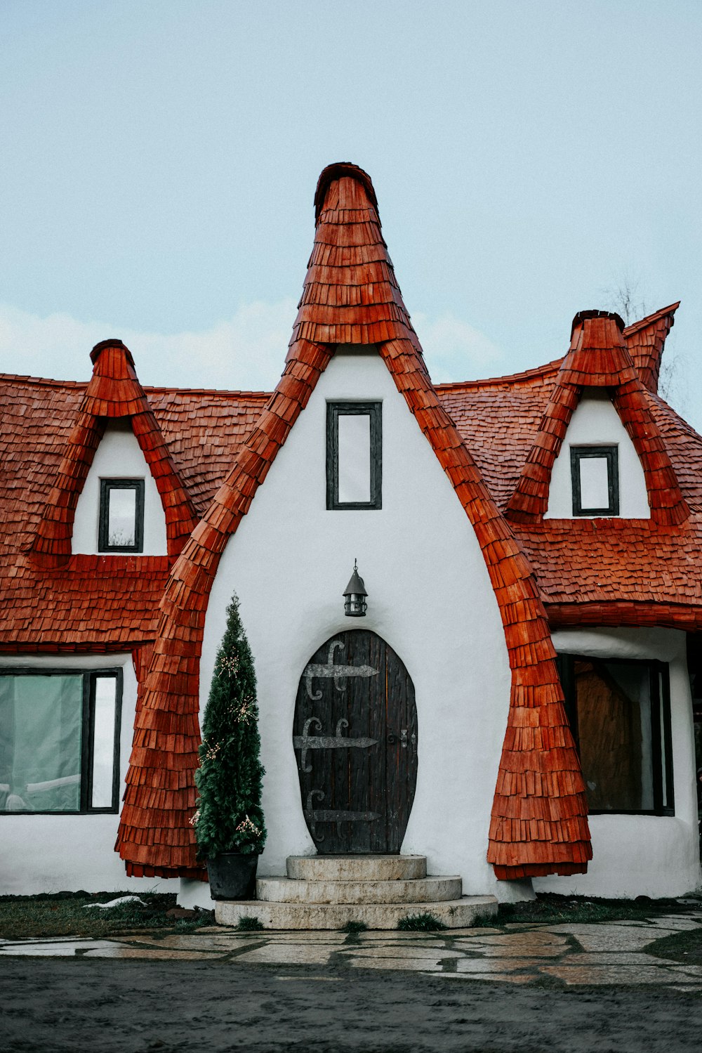 a white and red house with a red roof