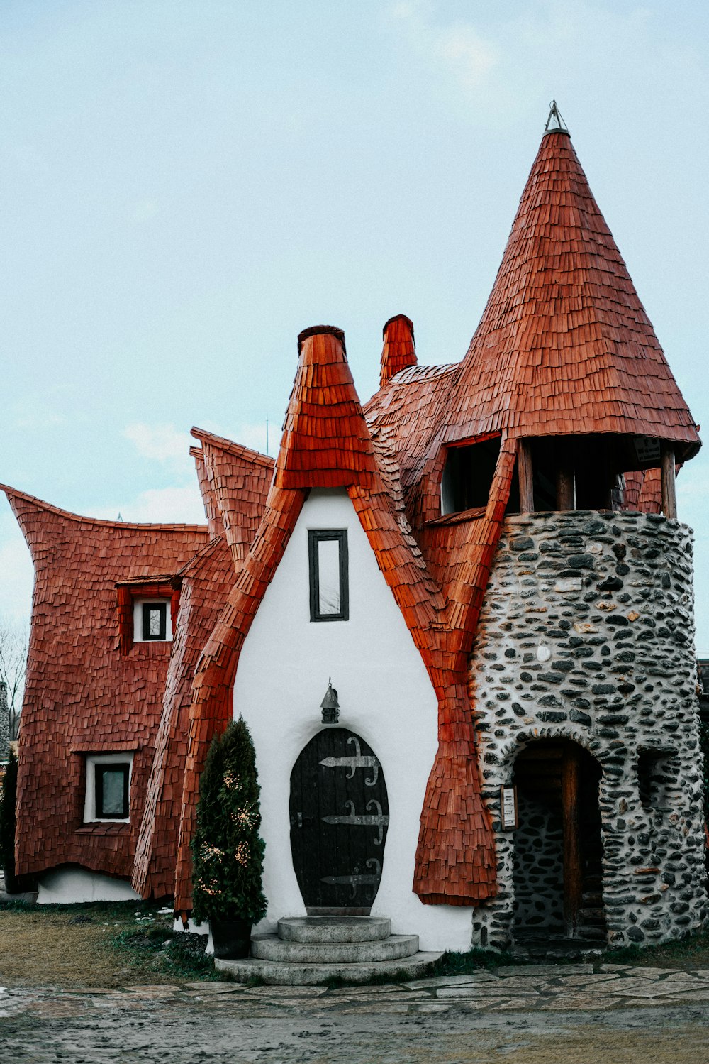 a white and brown house with a red roof