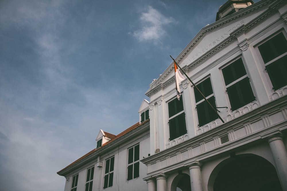 a white building with a flag on top of it