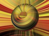 A 3D torus with a smooth gradient of yellow, green, and red hues is centered against a dynamic, striped background of similar colors, giving an impression of motion or depth.