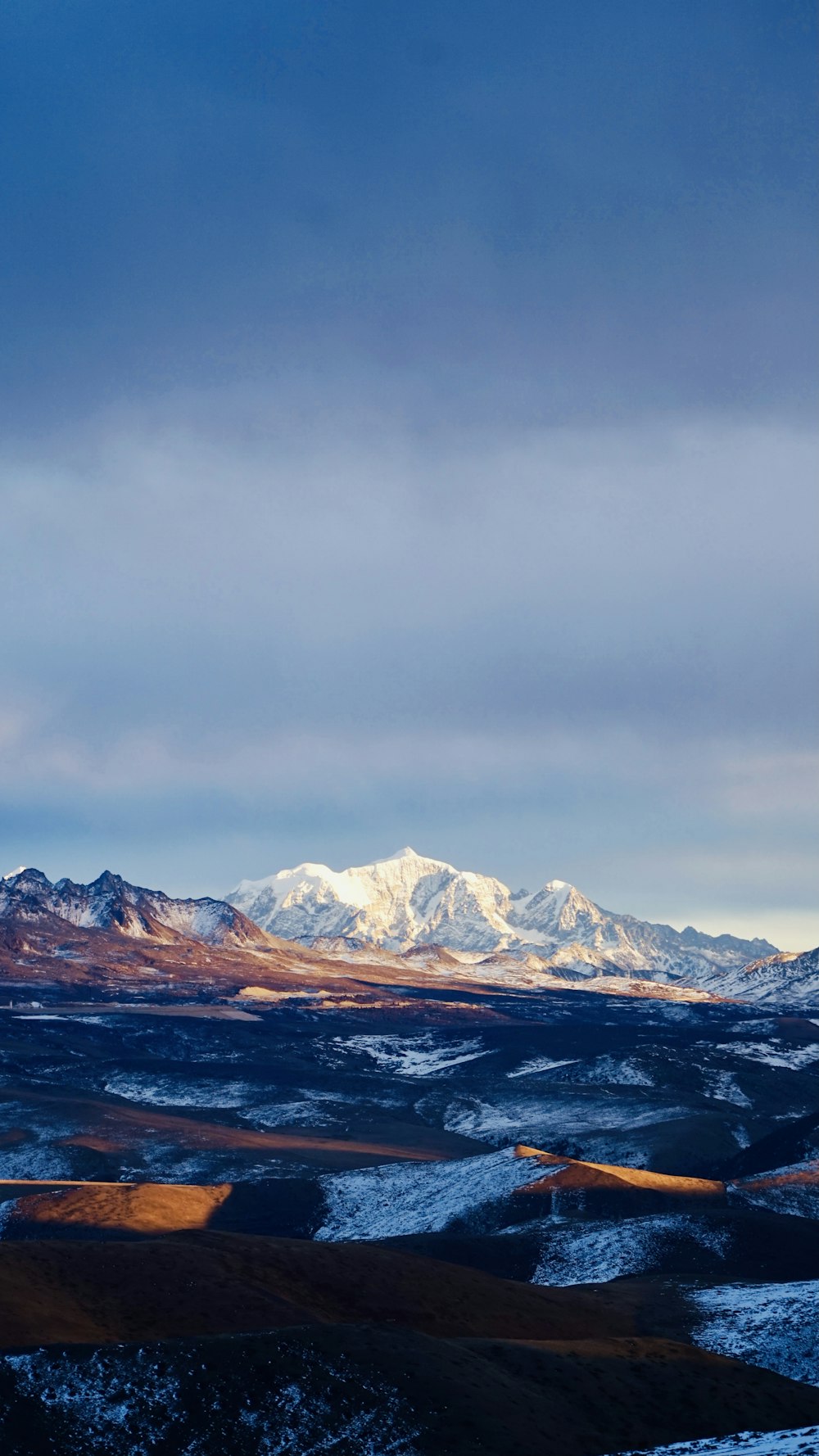 a view of a snowy mountain range from a distance