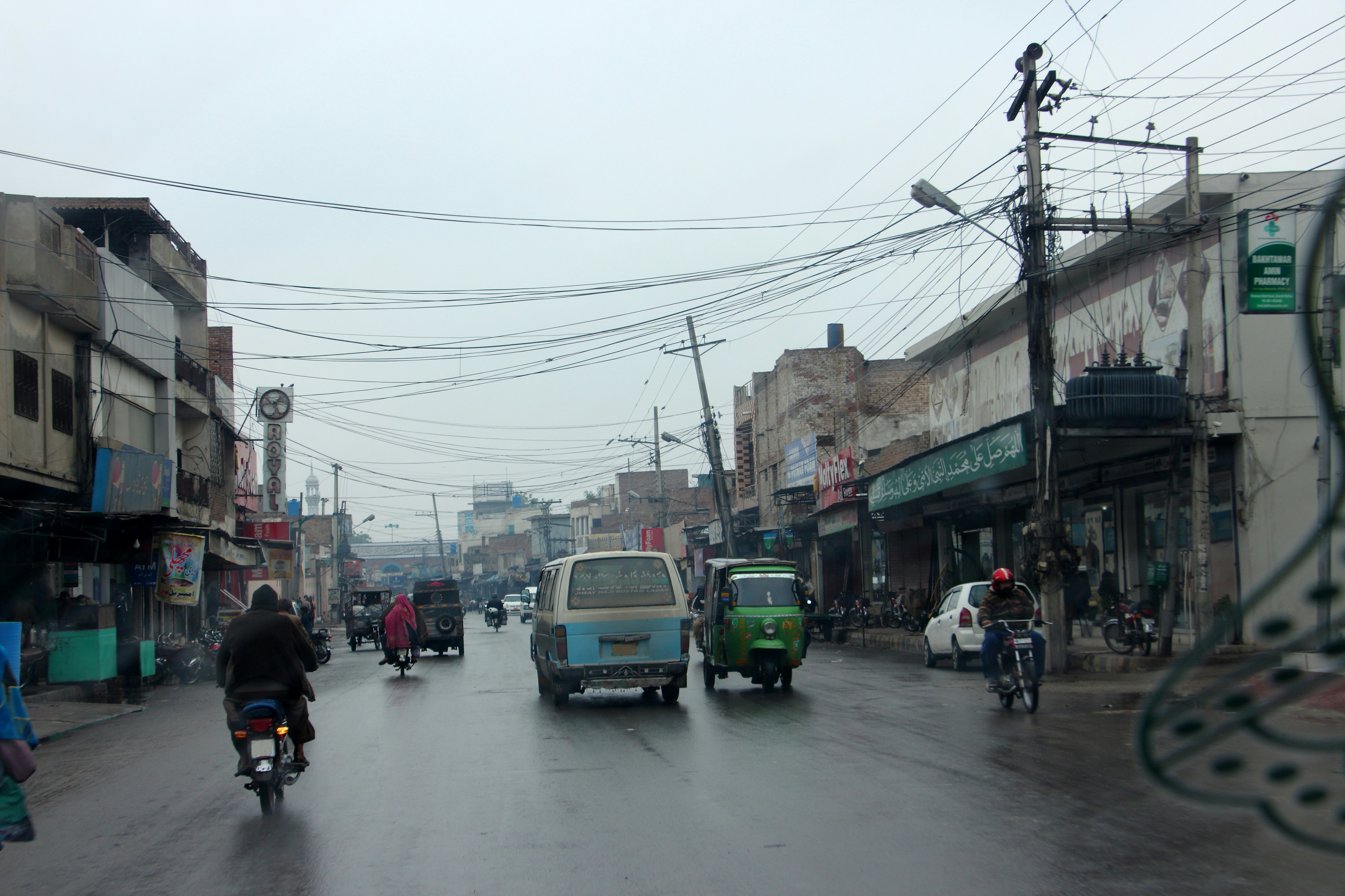 a group of people riding motorcycles down a street
